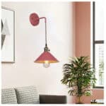 Applique murale suspendue scandinave avec interrupteur dans sa version terracotta, accrochée à un mur dans un salon.